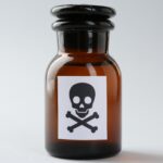 Brown glass bottle with a skull and crossbones warning label, symbolizing poison or toxic substances.