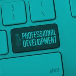 Computer keyboard with a highlighted key labeled ‘Professional Development.’