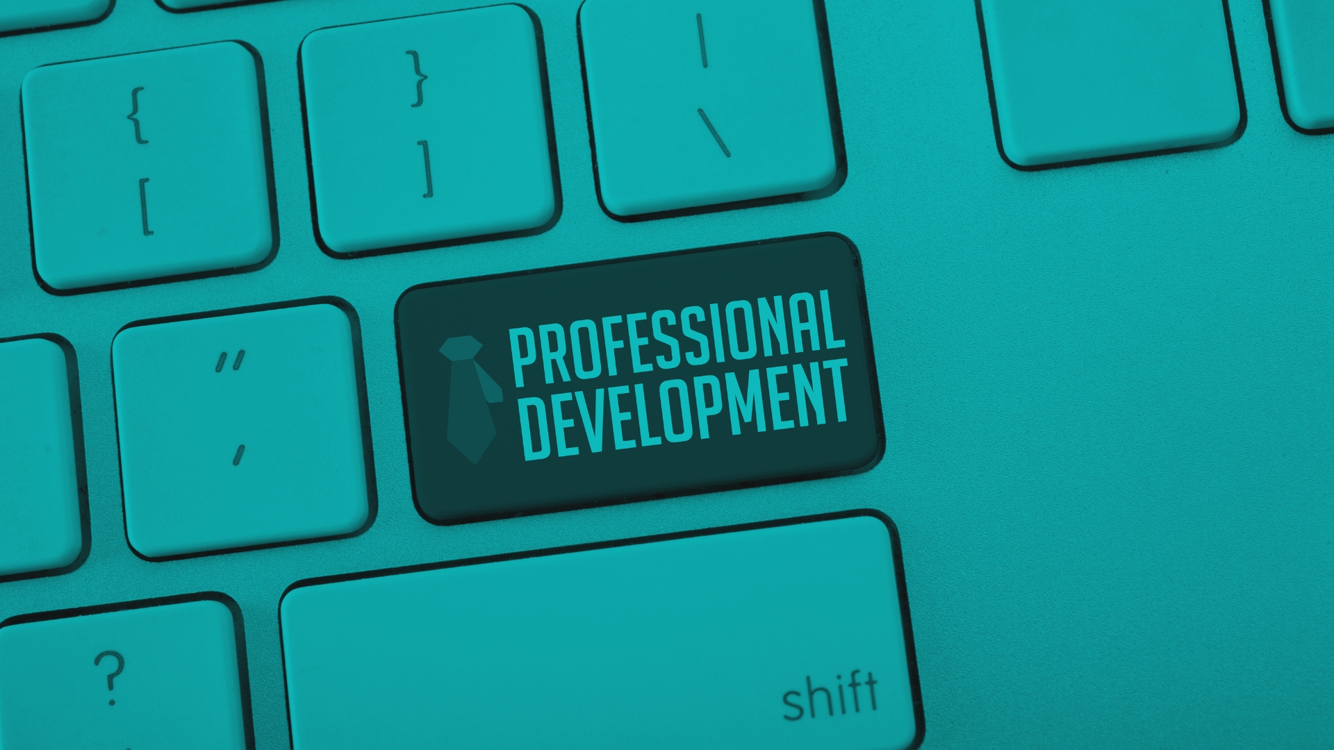 Computer keyboard with a highlighted key labeled ‘Professional Development.’