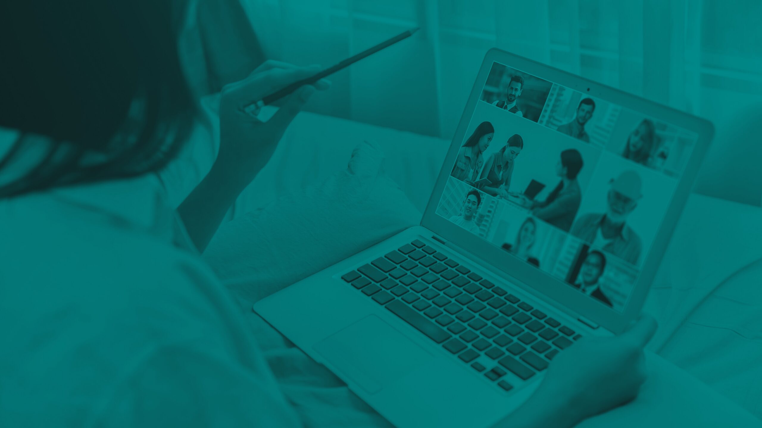 Close-up of a laptop displaying a multi‑person video meeting.